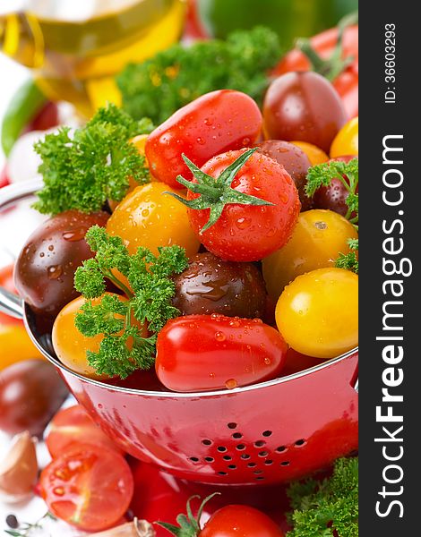 Assorted fresh cherry tomatoes, herbs and spices, close-up, vertical