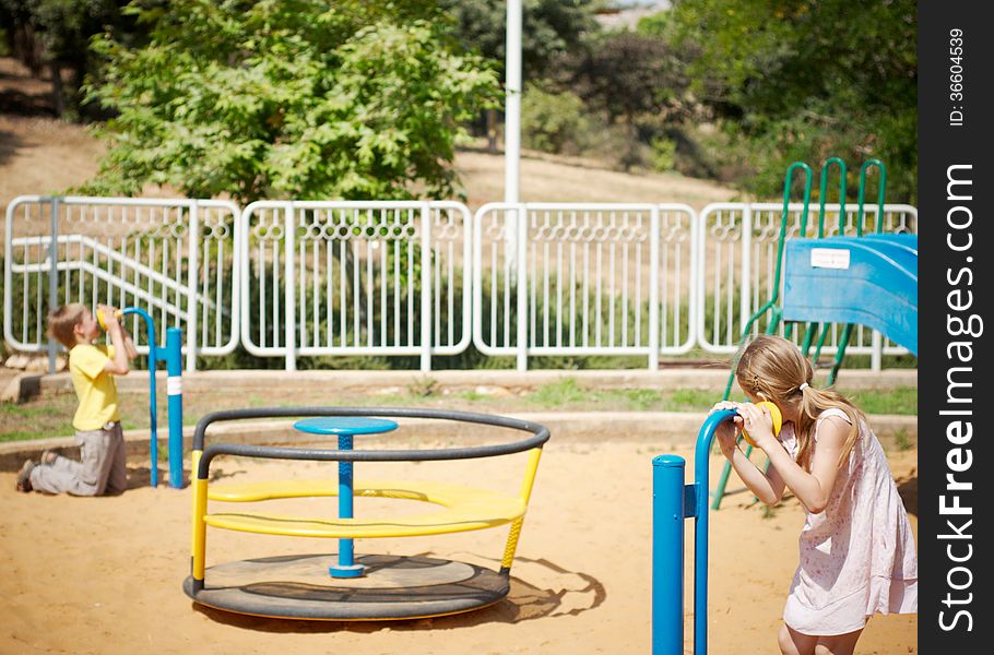 Boy and girl playing on the playground in the game with the sound - one says to the pipe, the other on the other end hears