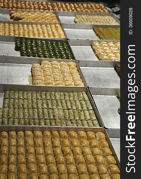 Various turkish baklava on trays in a shop. Various turkish baklava on trays in a shop