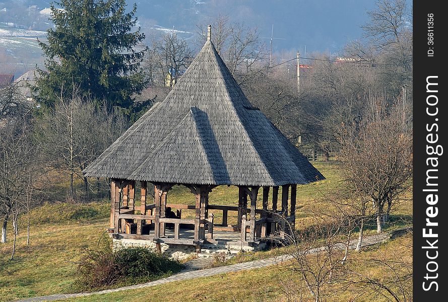 Wooden pavilion in a mountain meadow.
