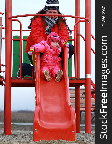 Gorgeous baby girl playing in the park with her mother. Gorgeous baby girl playing in the park with her mother