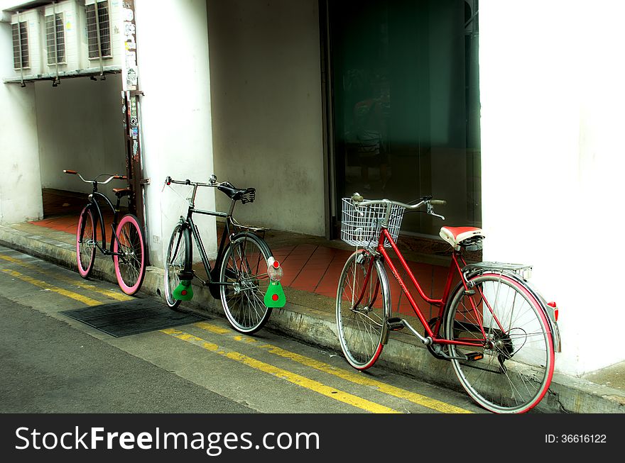 Three bikes parked on a side street