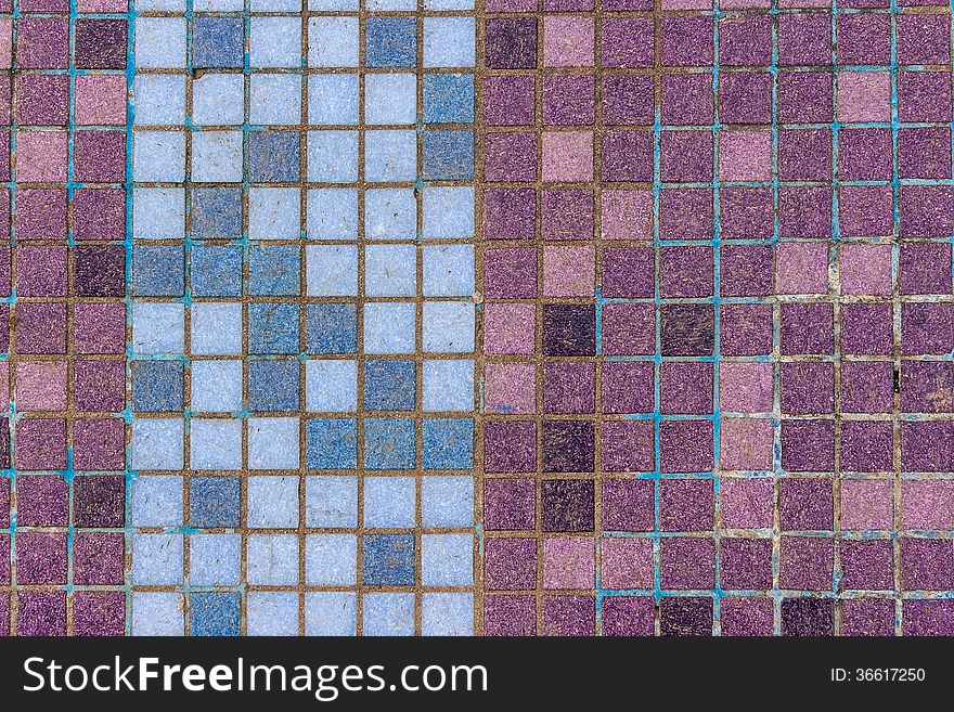 Old mosaic tiles of different colors lined in vertical blue pattern. Old mosaic tiles of different colors lined in vertical blue pattern