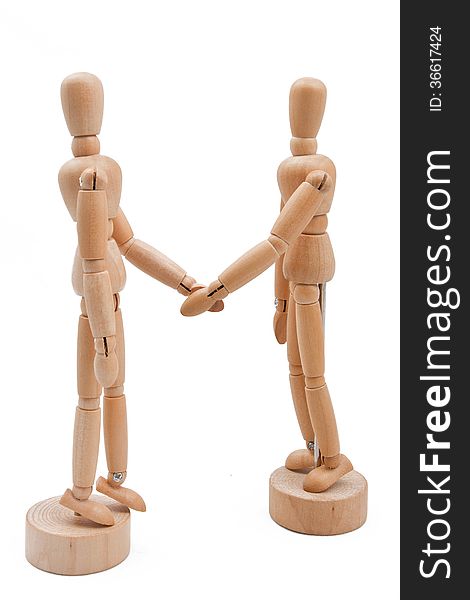 Wooden models create a business partnership agreement.