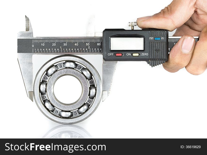 Metal vernier caliper and Ball bearings on white background. Metal vernier caliper and Ball bearings on white background