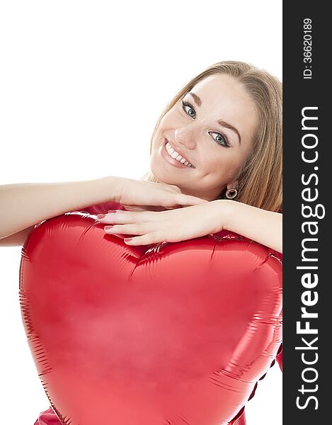 Smiling woman holding red heart balloon over white background. Valentines day concepts.