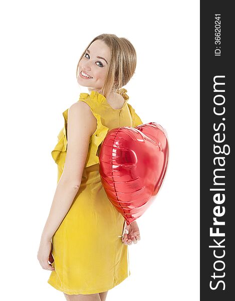 Woman holding red heart balloon.