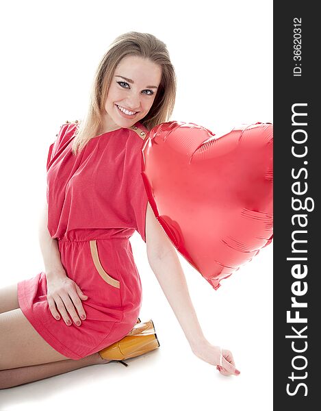 Smiling woman with red heart balloon