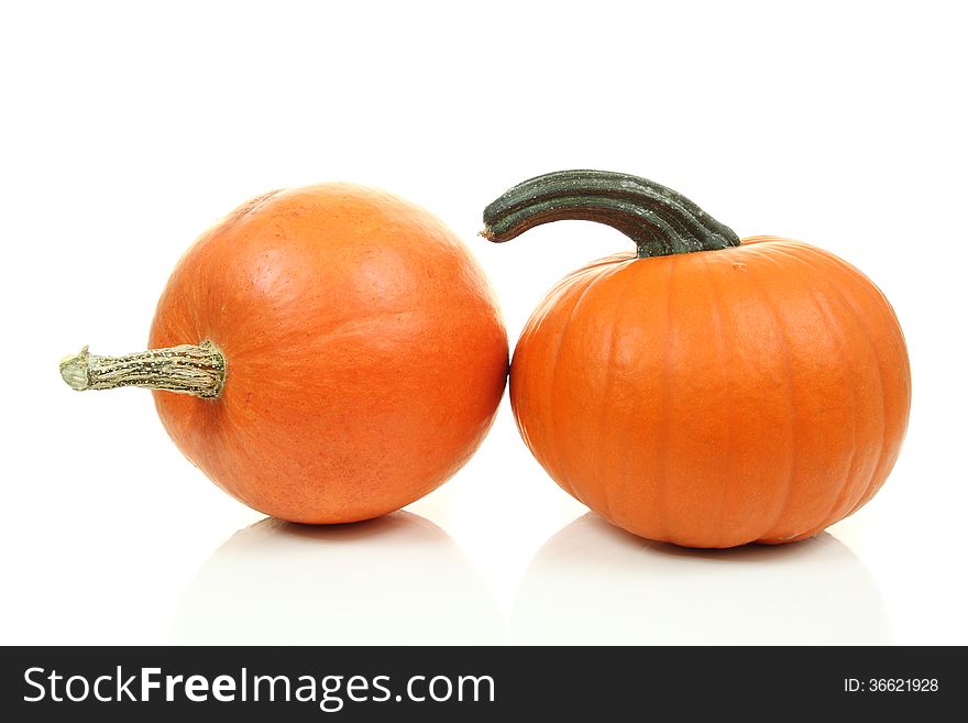 Two fresh orange pumpkins isolated on white background