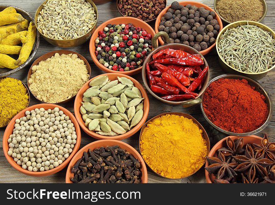 Colorful spices in ceramic and metal containers - beautiful kitchen image.