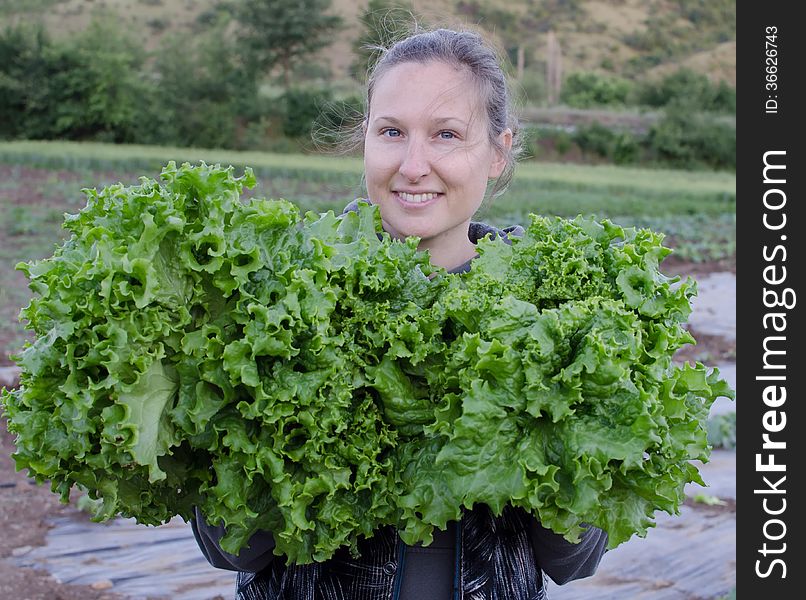 Girl holding an organic green salad. Girl holding an organic green salad