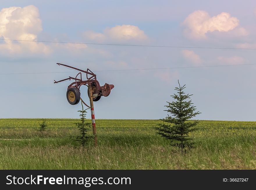 Antique plow on a post
