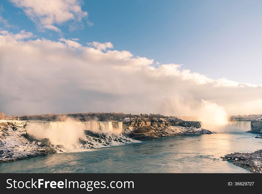 Frontal view of the magnificient Niagara Falls, ready for spectacular sunset. Frontal view of the magnificient Niagara Falls, ready for spectacular sunset.