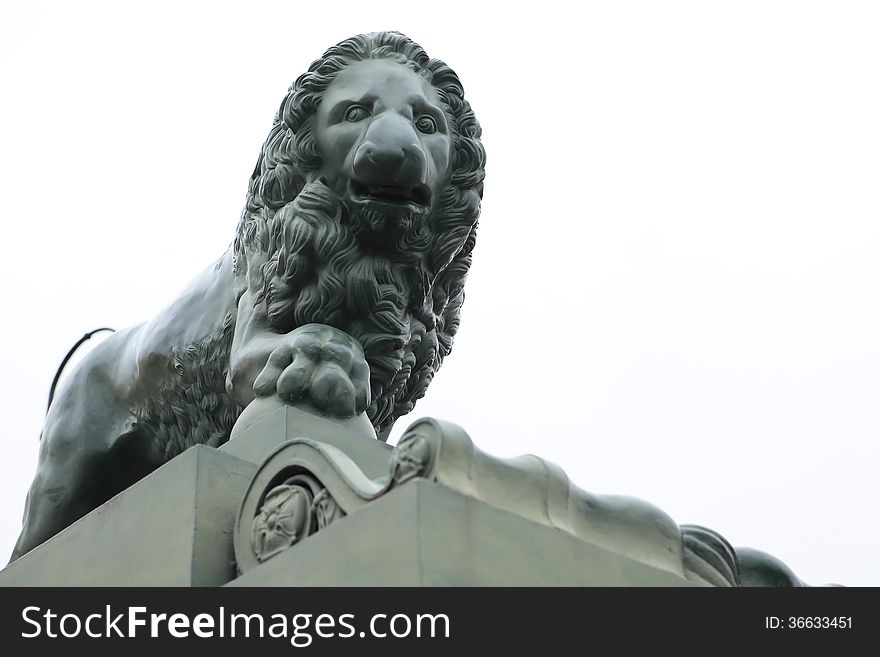 Marble lion sculpture closeup on white background