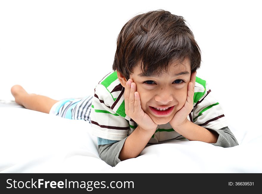 Portrait boy lay down on white bed