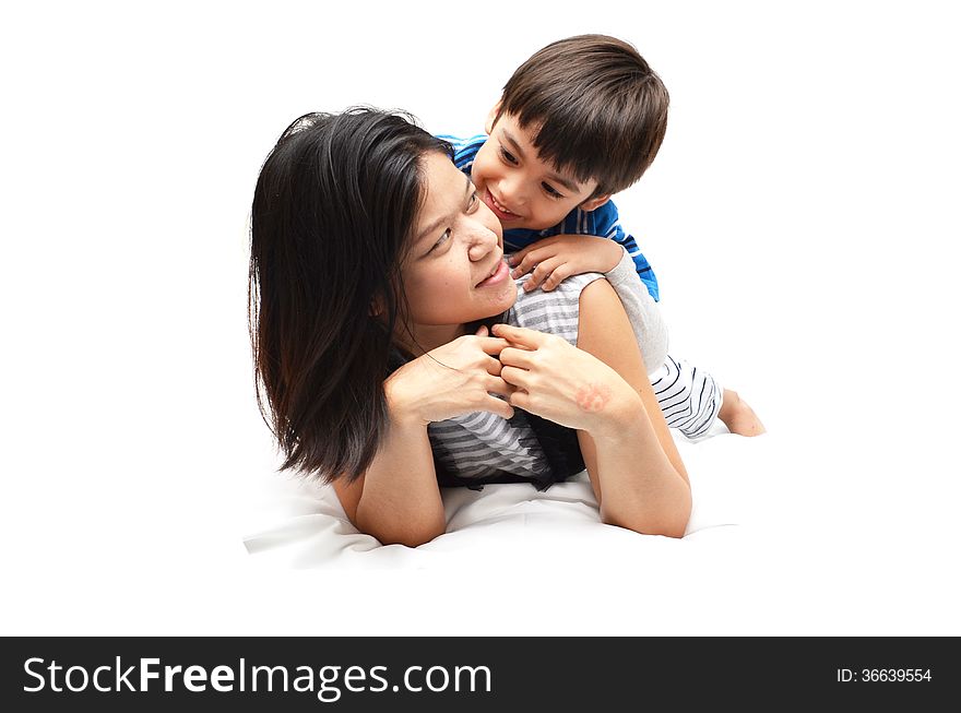 Mother And Son Lying In Bed Together