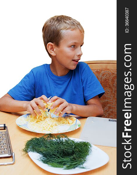 The boy helps to cook food at a table in kitchen. The boy helps to cook food at a table in kitchen.