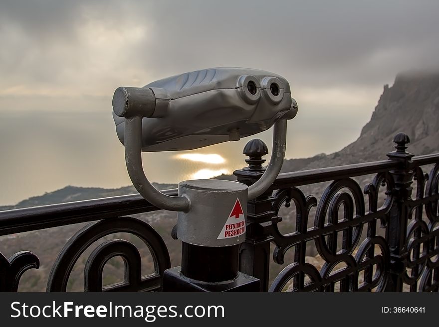 Binoculars telescope looking Foros panorama from the observation point of Christ's resurrection church