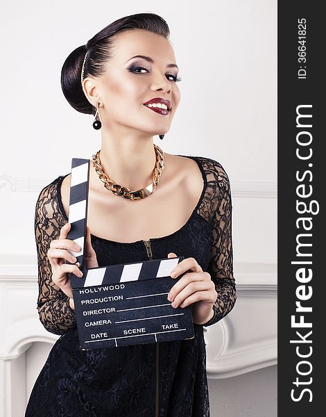 Portrait Of Beautiful Girl With Cinema Clapperboard
