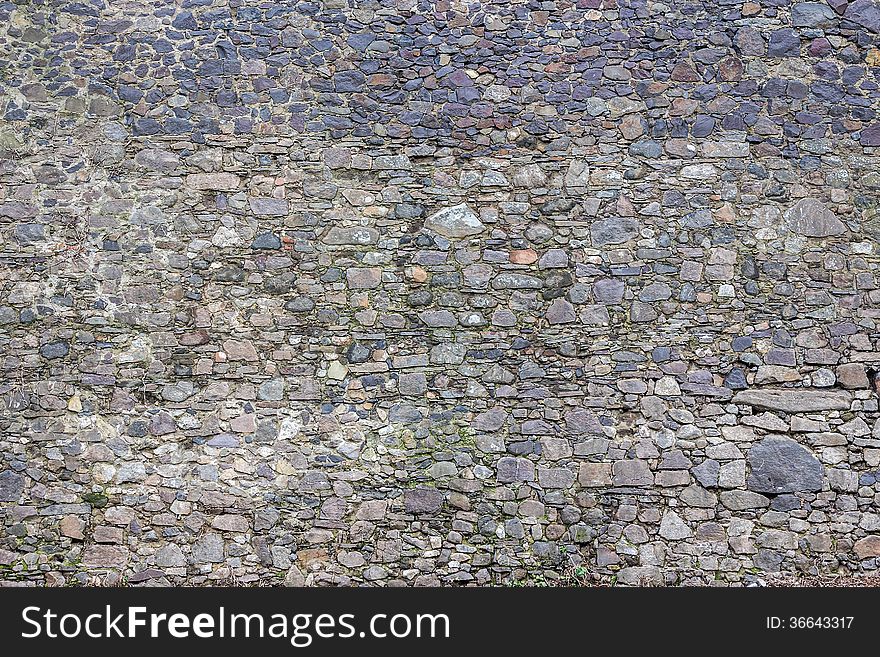 Wall of the sharp stones of various sizes