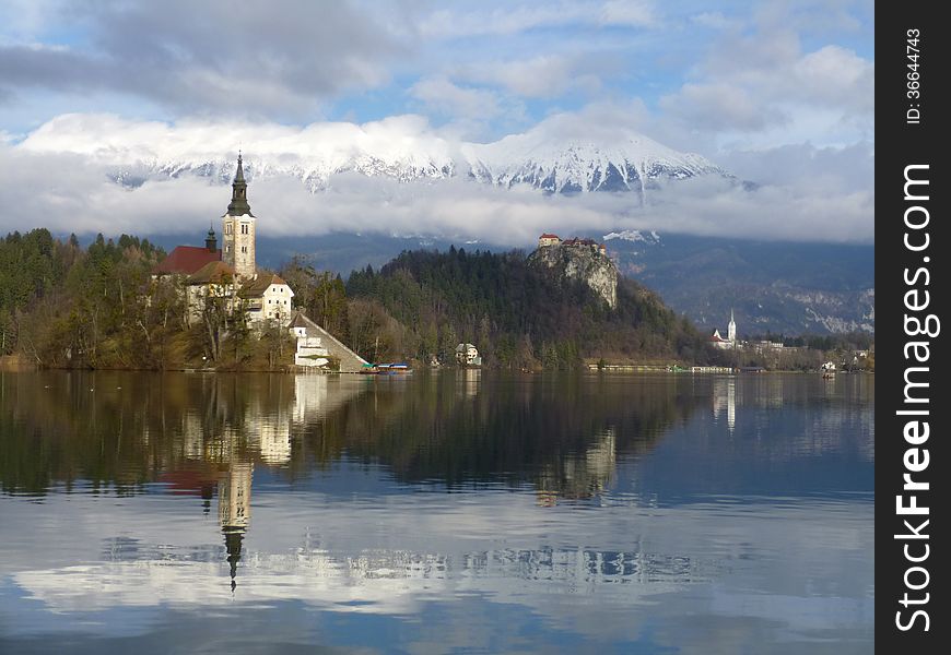 Island at the Lake of Bled with a Castle behind. Island at the Lake of Bled with a Castle behind