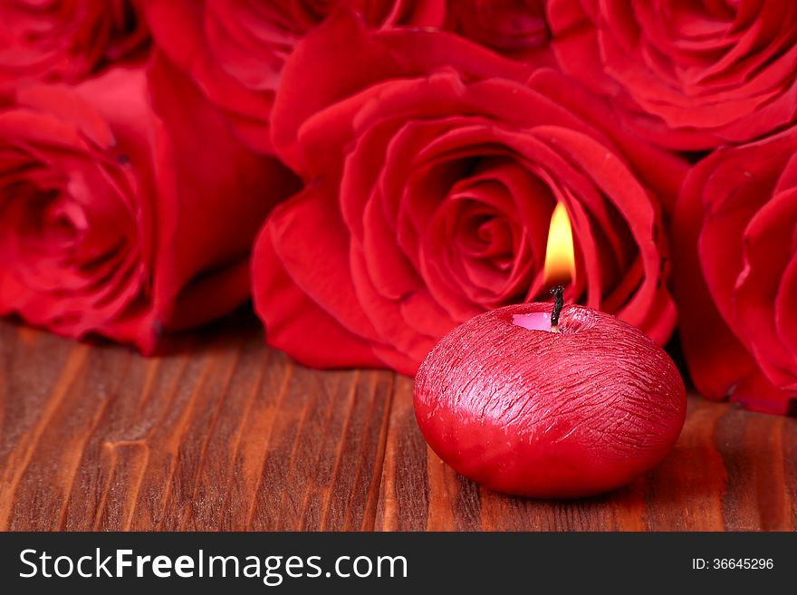 Romantic composition with red candles and roses. selective focus