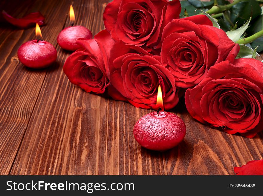 Romantic Composition With Red Candles And Roses.