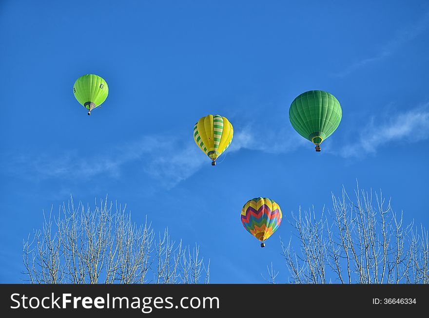 Multicolored and Striped Hot Air Balloons in the sky. Multicolored and Striped Hot Air Balloons in the sky