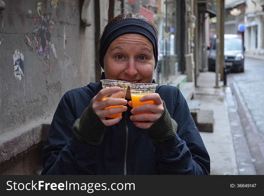 Girl holding two cups of juice in winter cold weather. Girl holding two cups of juice in winter cold weather