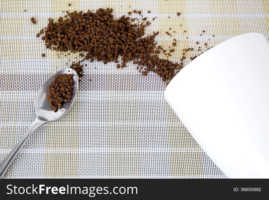 Instant coffee in spoon and out of cup