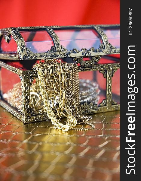 Golden jewelry in open treasure chest