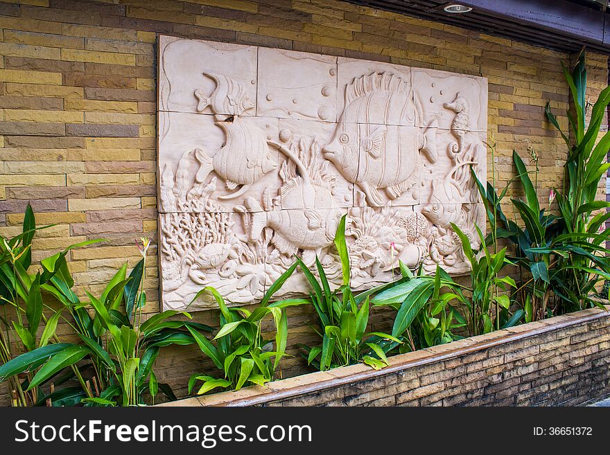 Statue decoration on wall made of sand