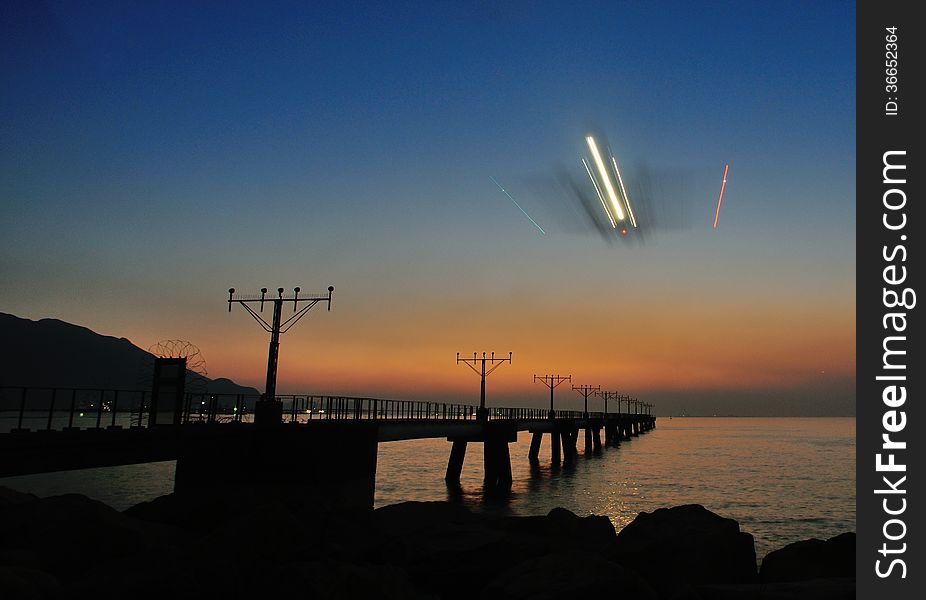 Air plane landing runway under sunset