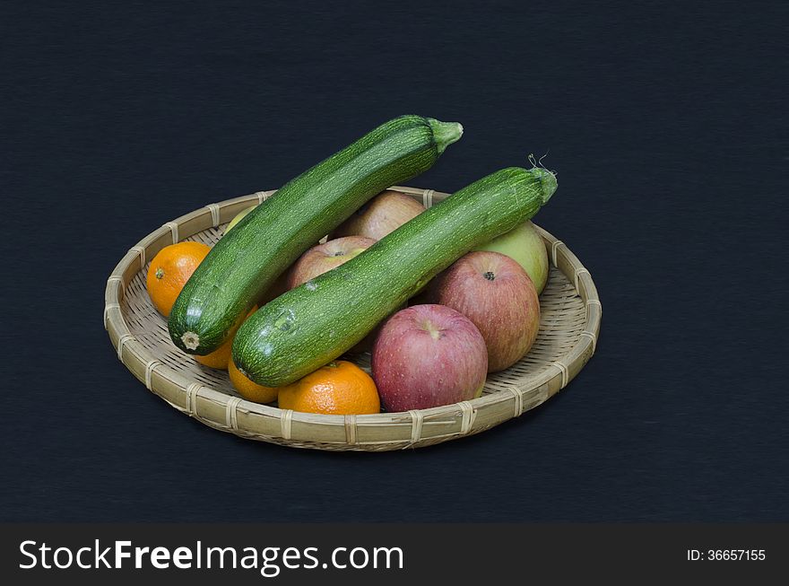 Fruit and zucchini in a rattan bowl. Fruit and zucchini in a rattan bowl.