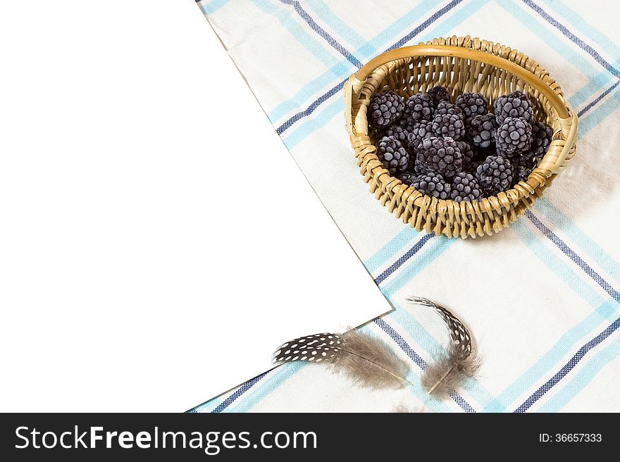 Frosted blackberry in wicker - blue rustic background. Frosted blackberry in wicker - blue rustic background