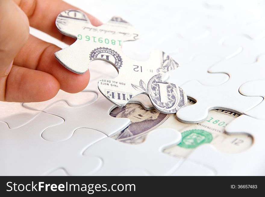 Hand holding a puzzle piece, Finance concept