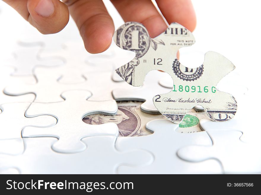 Hand holding a puzzle piece, Finance concept