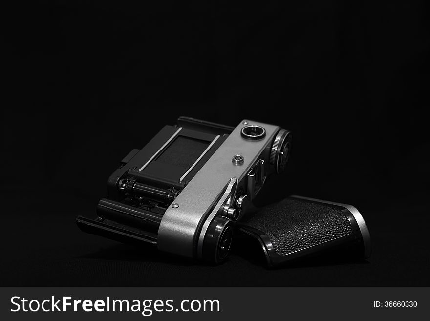 Analog retro photo camera on a dark background. Analog retro photo camera on a dark background.