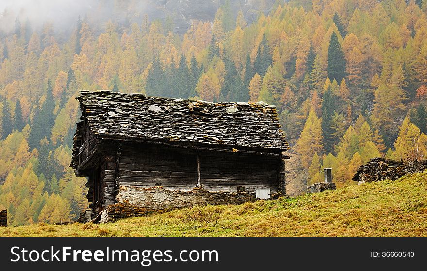 typical mountain hut in autumn landscape in Italy Alps. typical mountain hut in autumn landscape in Italy Alps