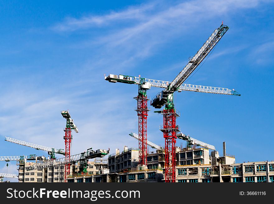 Cranes at construction site in Singapore.