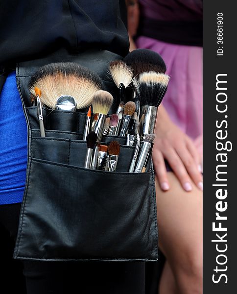 Make-up artist brushes at professional bag during location photo shoots in NYC