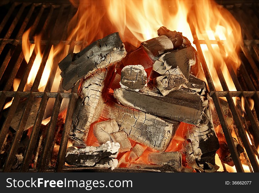 Glowing charcoal and flames in barbecue grill XXXL