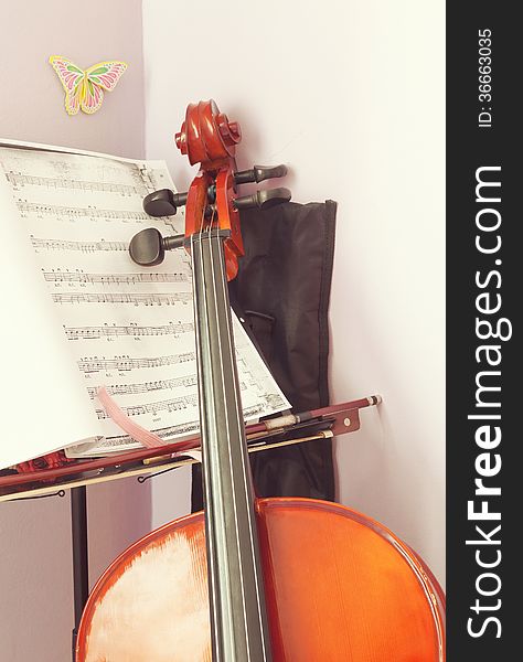 Corner of a child's room with cello and scripts ready for practice. Corner of a child's room with cello and scripts ready for practice.