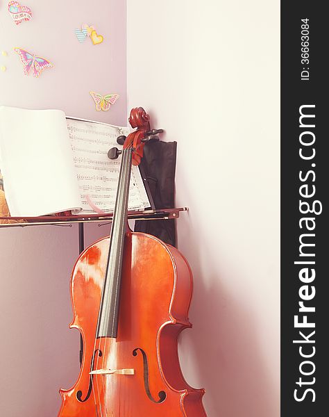 Corner of a child's room with cello and scripts ready for practice. Corner of a child's room with cello and scripts ready for practice.