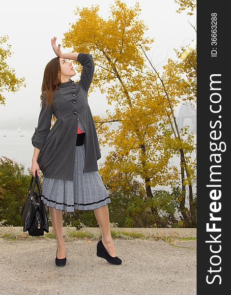 Fashionable young woman with hand bag