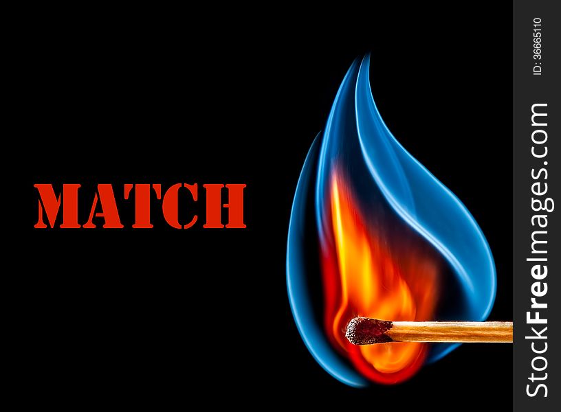 Wooden match is burning on black background