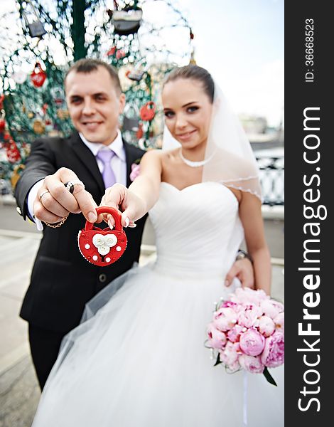 Happy Bride And Groom With A Padlock