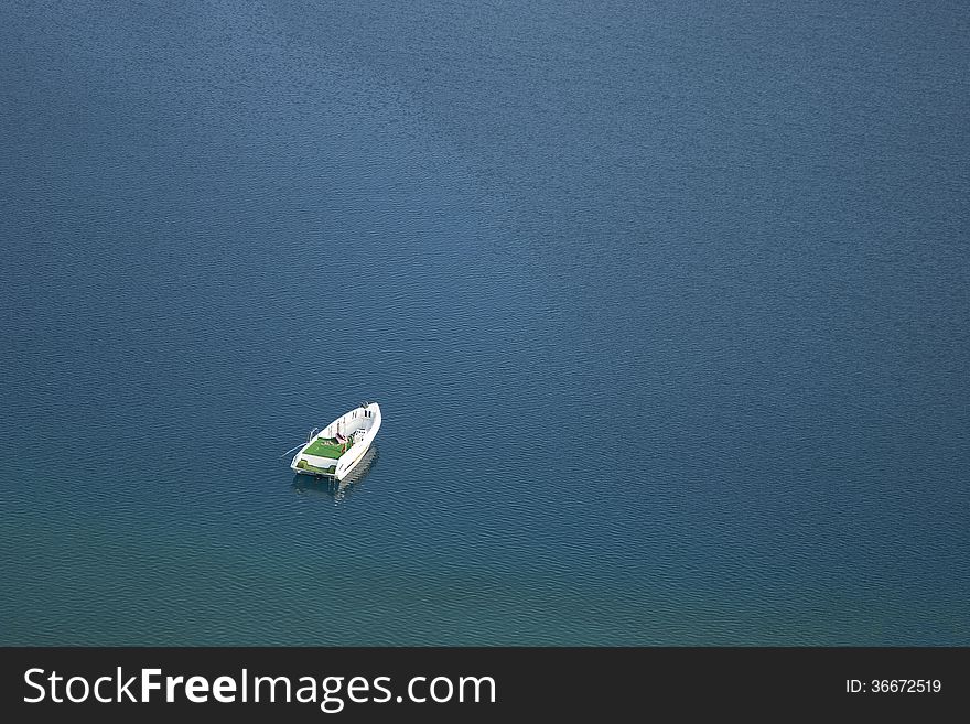 A white boat in blue waters. A white boat in blue waters