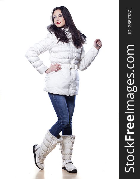 Pretty girl in winter clothes posing on white background. Pretty girl in winter clothes posing on white background