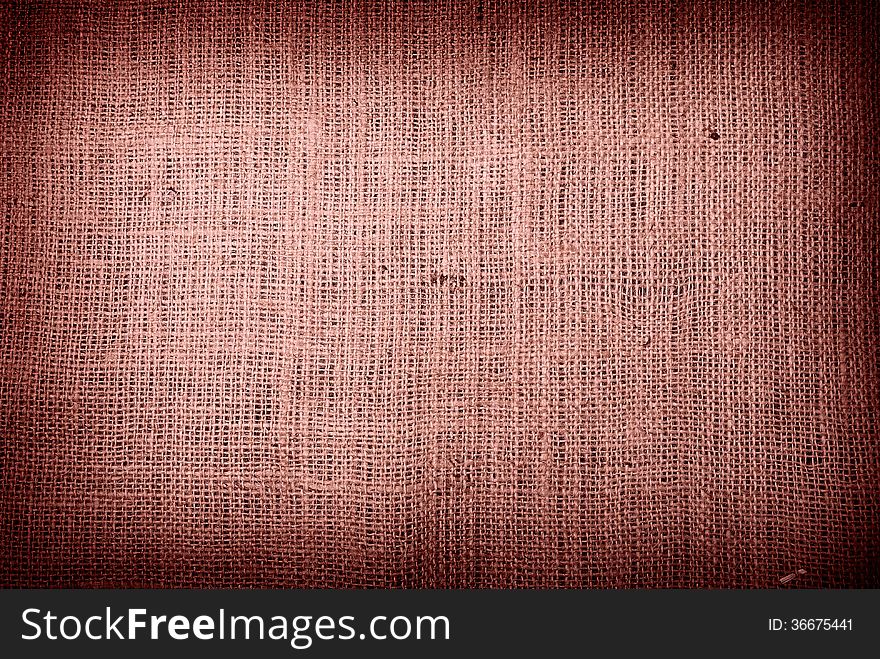 Fragment of rough brown textile background. Fragment of rough brown textile background